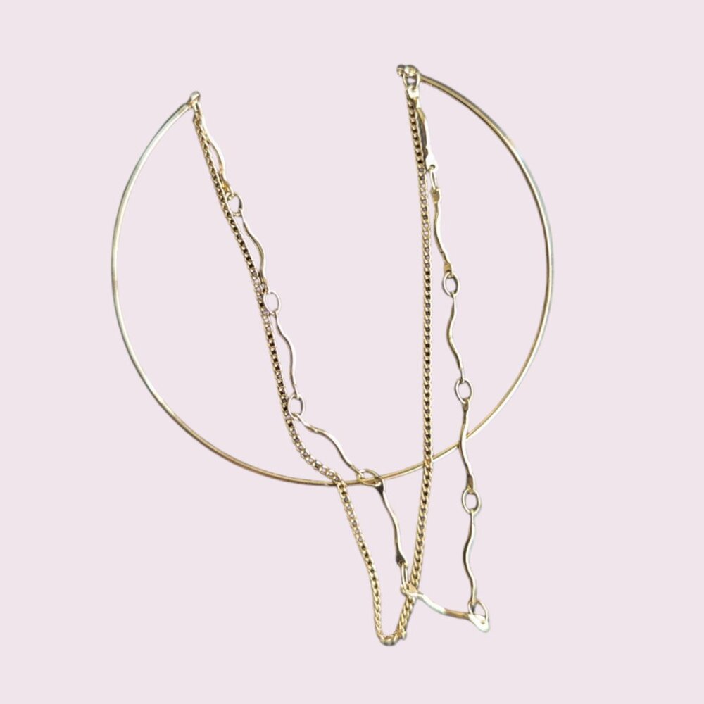 Gold cuff bangle with attached gold chain bracelet